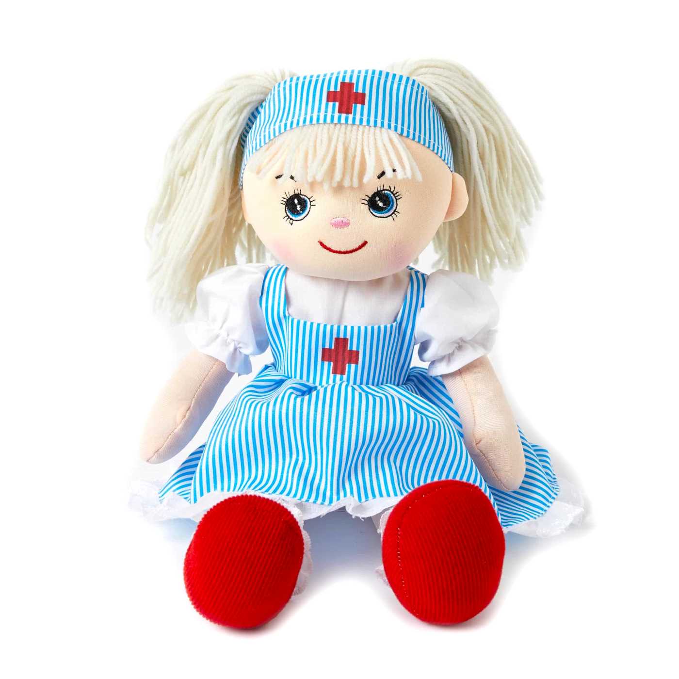 Madison is a soft body doll with blue eyes, pale skin and light blonde hair with a fringe. She is wearing a blue and white striped dress with a red cross in the middle of the bib. She has bright red boots on and a white puffy sleeve shirt with white frills on the edge of the dress. 